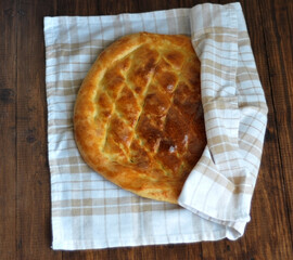 Freshly baked fragrant homemade bread flatbread on the table under the morning sun