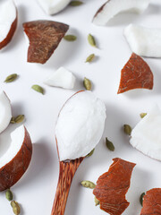 coconut oil on a white background. With pieces of coconut
