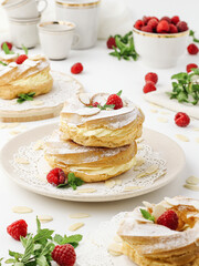 Cream puff rings (choux pastry)  with raspberries on  white 