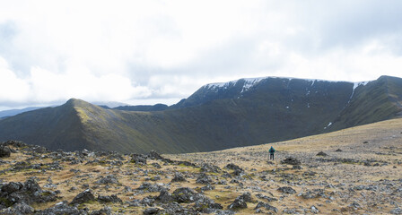 Fototapeta premium A walker heading towards Lower Man and Helvellyn in the Lake District