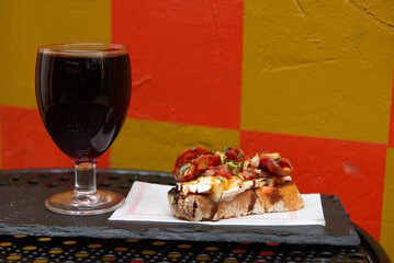 Plated bruschetta with a side of wine