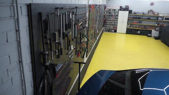 a beautifully laid out tool for carrying out car body repair in a car service station, restoration of defective and broken cars by a master, repair garage, auto tuning place