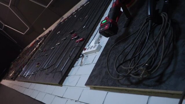 a beautifully laid out tool for carrying out car body repair in a car service station, restoration of defective and broken cars by a master, repair garage, auto tuning place