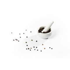 Close-up of black pepper in white mortar and pestle.