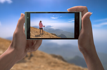Girl hiker on a smartphone screen
