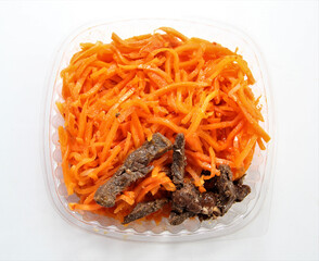 Salad Carrots with beef. Salad in a disposable bowl.