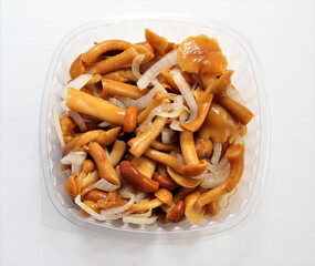 Honey mushrooms marinated with onions. Lunch in a disposable dish.