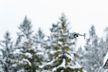 Fototapeta na wymiar Quadcopter launch in winter snowy forest.