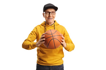 Smiling elderly man in a yellow sweathsirt holding a basketball