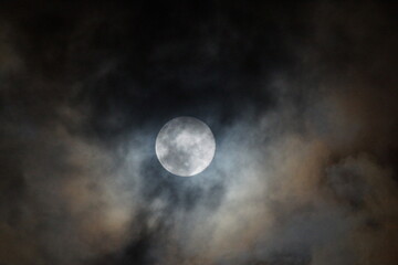 Worm Moon through the clouds
