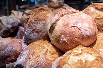 Large loaves of bread on the counter of a bakery.