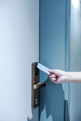 A person who opens the door with a card