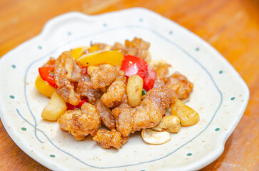 Stir fried chicken with cashew nuts on a wooden table Made by a Chinese chef,Soft focus image.
