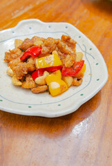 Stir fried chicken with cashew nuts on a wooden table Made by a Chinese chef,Soft focus image.