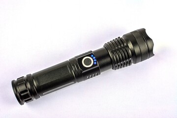 modern black metal flashlight isolated on white