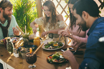 Young friends having fun eating brunch at healthy food restaurant - Focus on man hands