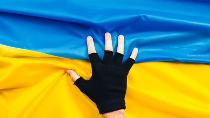 Hand holds flag of ukraine