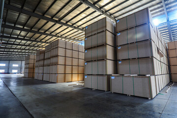 Particleboard products are stacked in the warehouse in a factory in North China