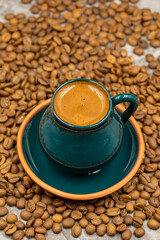 Turkish coffee in a rustic cup. Coffee beans background. close up