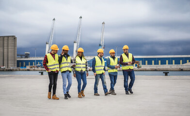 Multiracial people working together at shipping port outdoor - Focus on senior african woman face