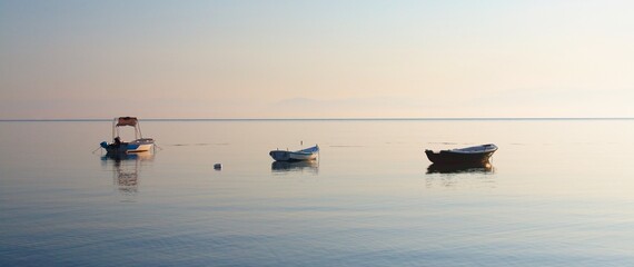 Fishing boats in the resort of Moraitika on the shores of the Ionian Sea on the island of Corfu in Greece.