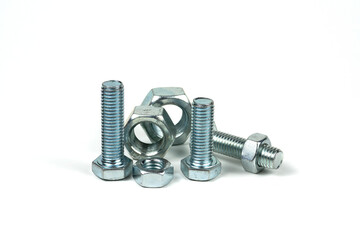Several silver metal mounting bolts with nuts on a white background. Close-up