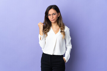 Young caucasian woman isolated on purple background with unhappy expression