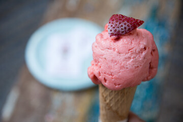 Strawberry ice cream in a cone