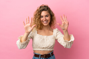 Young blonde woman isolated on pink background counting nine with fingers