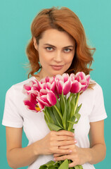 young woman with tulip flower bouquet on blue background