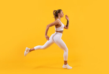 Fototapeta na wymiar active sport woman runner running on yellow background