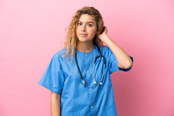 Young surgeon doctor woman isolated on pink background having doubts
