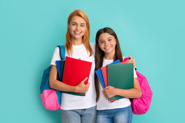 cheerful mother and daughter hold notebook and backpack ready to study, learning