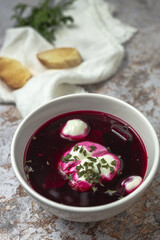 Traditional Ukrainian and Russian national red borscht soup en bol with sour cream and herbs