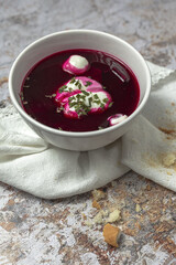 Traditional Ukrainian and Russian national red borscht soup en bol with sour cream and herbs
