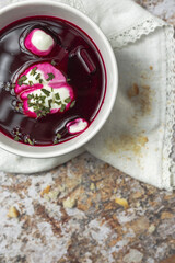 Traditional Ukrainian and Russian national red borscht soup en bol with sour cream and herbs