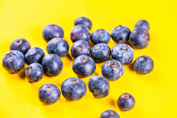 fresh blueberries on yellow  background