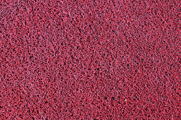 Red synthetic carpet texture background