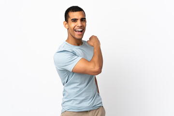 African American man over isolated white background celebrating a victory