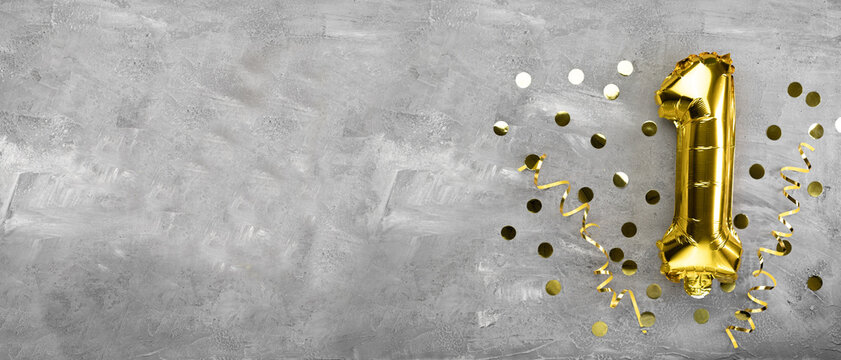 Yellow foil balloon number, number one on a concrete background. Birthday card with lettering 1. Anniversary concept. for anniversary, birthday, new year celebration.