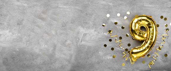 Yellow foil balloon number, number nine on a concrete background. Birthday card with inscription 9. Anniversary concept. for anniversary, birthday, new year celebration. banner,
