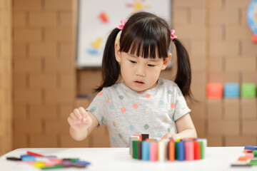 young girl play number sticks fine motor skill game for homeschooling