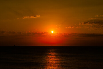 a wonderful sunset and the sun winking through the clouds