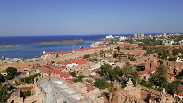 Aerial 4k Famagusta Walled City, old town and Varosha landscapes in North Cyprus surrounded with old streets, shops, touristic sightseeings, mosque, cathedral, castle with a sunny day in Cyprus.