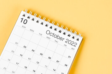 October 2022 desk calendar on light yellow background.