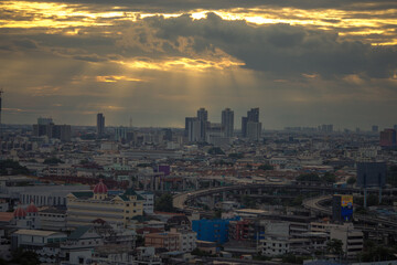 The high angle background of the city view with the secret light of the evening, blurring of night lights, showing the distribution of condominiums, dense homes in the capital community