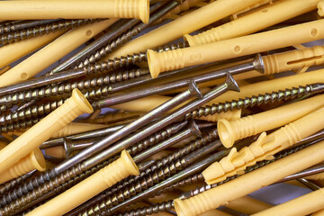 Bunch of tapping construction screws with plastic dowels for fixture. Selective focus. - 493775310