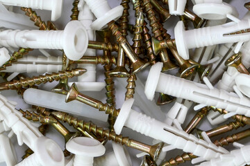 Bunch of tapping construction screws with plastic dowels for fixture. Selective focus. - 493775318