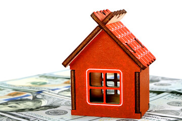 Model of small family house standing on background of dollars banknotes. Cut out. Selective focus. Isolated on white. Saving money for buying property. - 493775356
