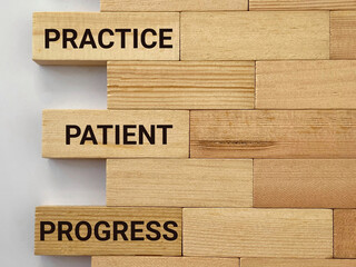 Inspirational Quote - practice patient progress text on wooden blocks background. Stock photo. 